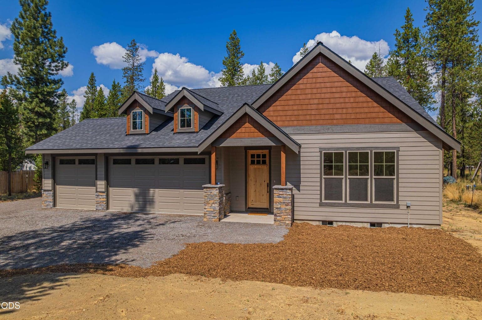 Attractive front elevation showcasing quality craftsmanship, clean design, and the peaceful pine setting of this Covina Road home.