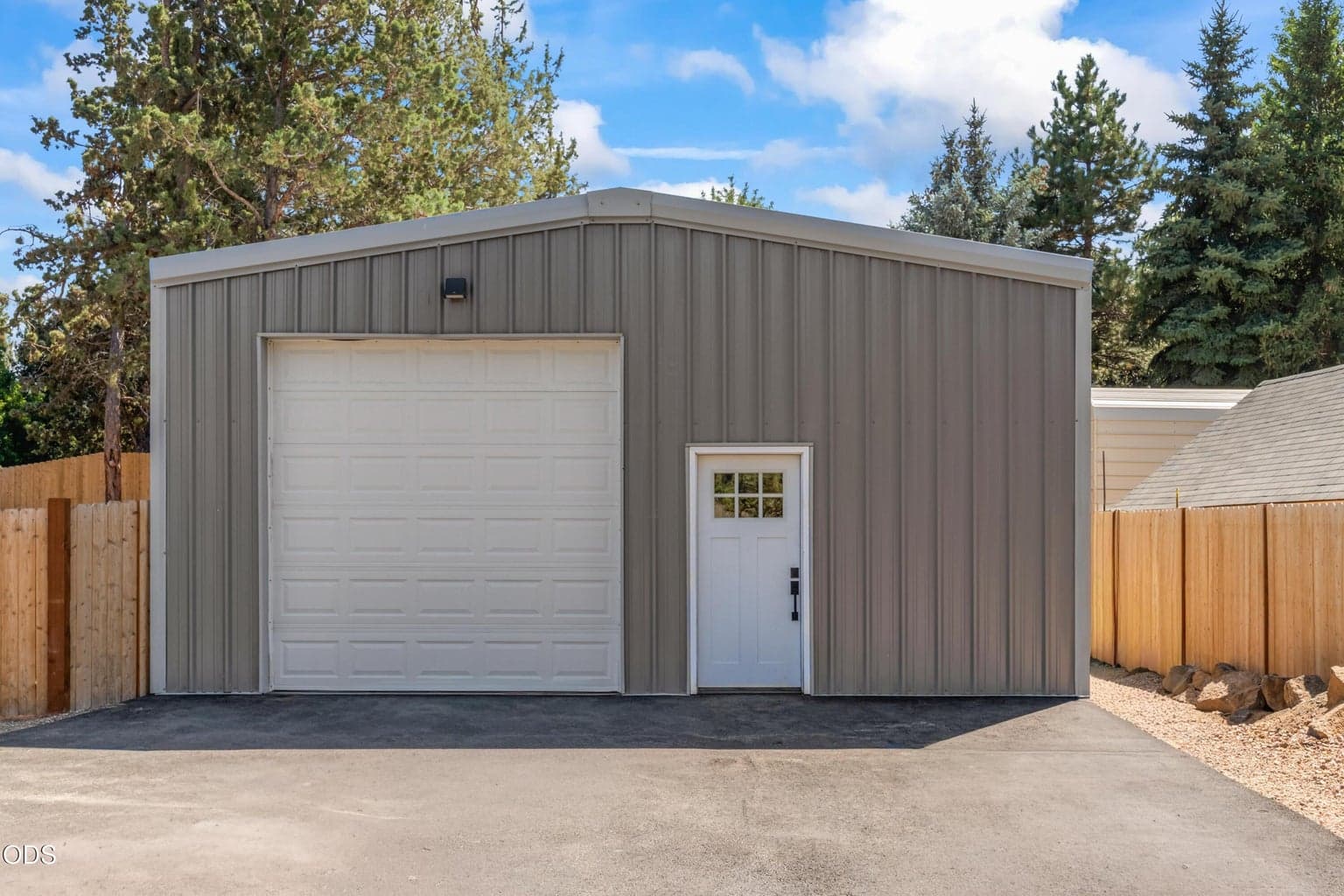 The 26x40 detached shop/4-car garage with 14-ft ceilings fits vehicles, boats, RVs, storage or a workshop.