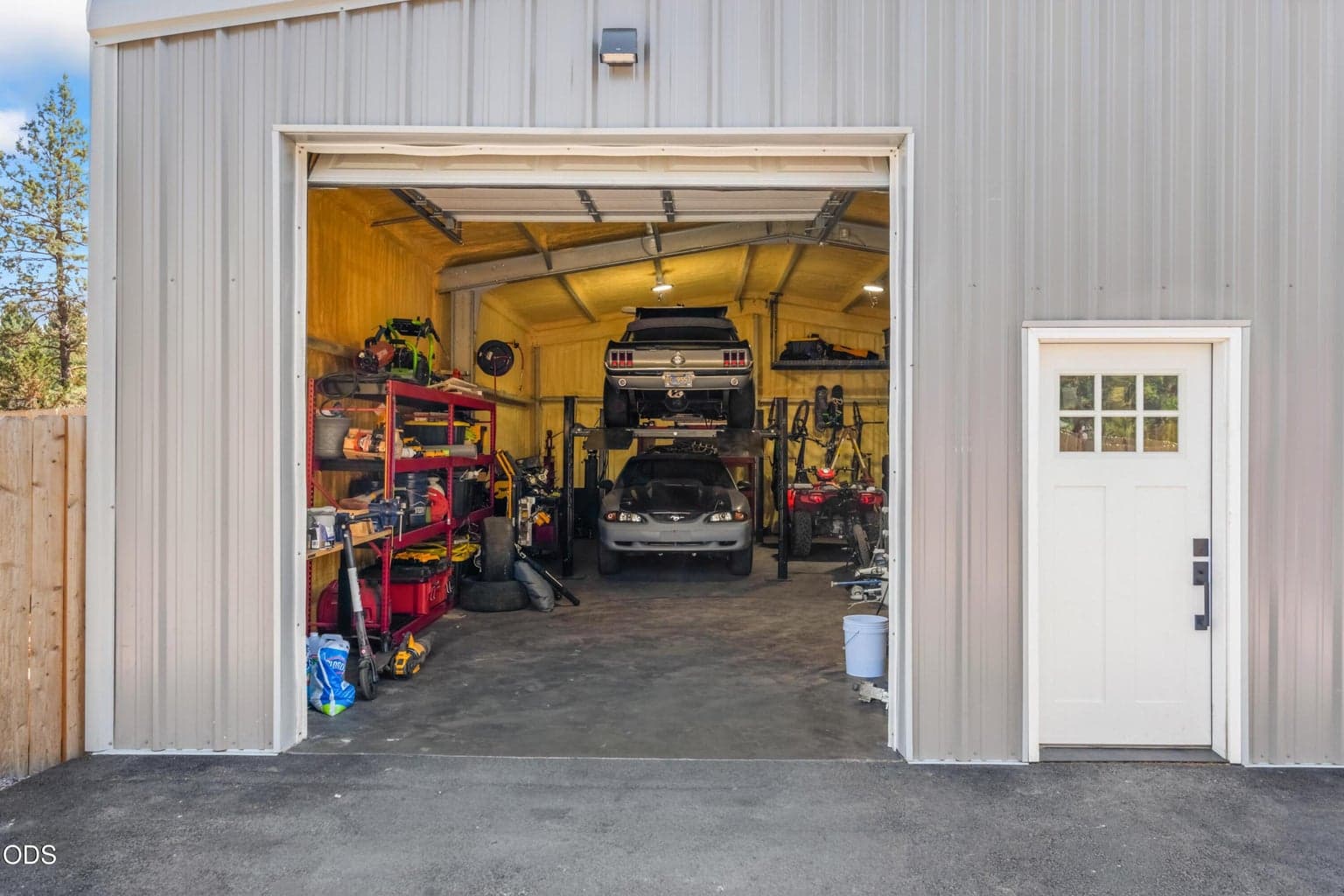 The 26x40 detached shop/4-car garage with 14-ft ceilings fits vehicles, boats, RVs, storage or a workshop.