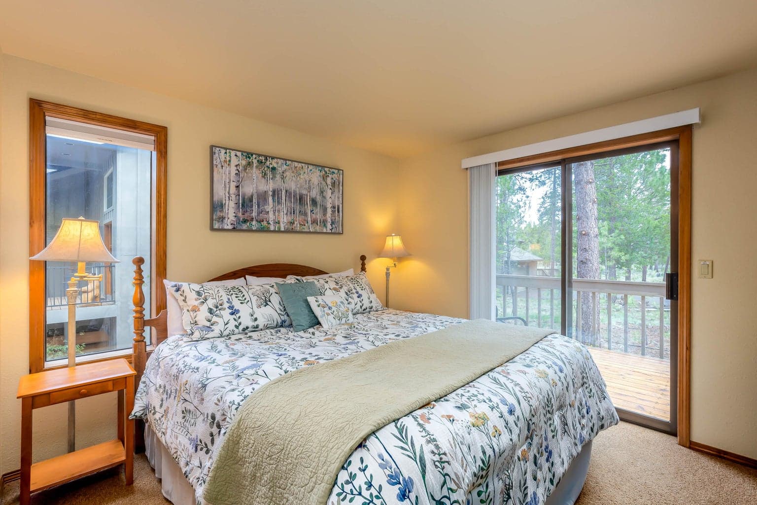 Main floor primary bedroom with a king bed & sliding glass door to the back deck