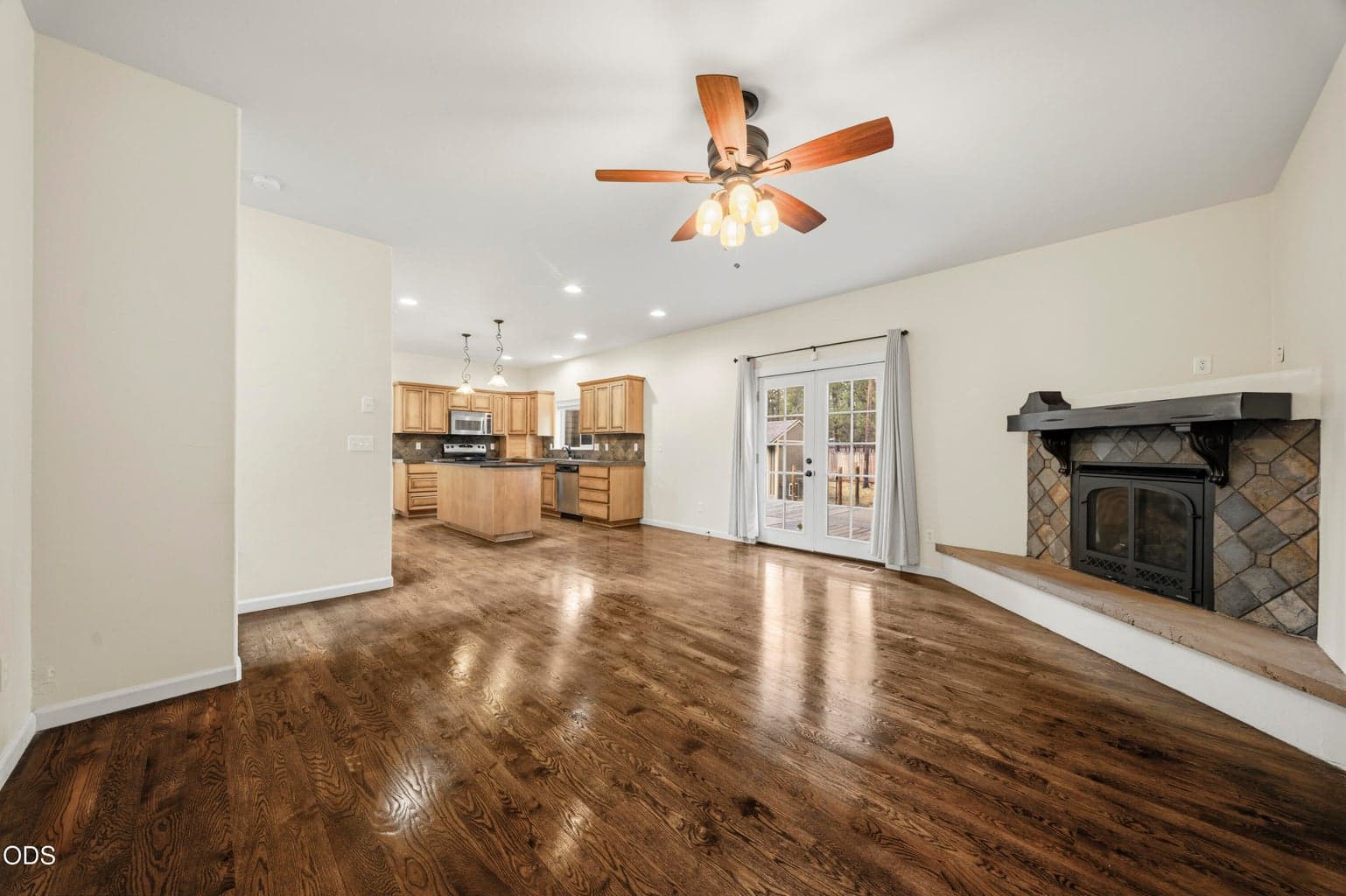 Great room with hardwoods and french doors out to a huge deck!