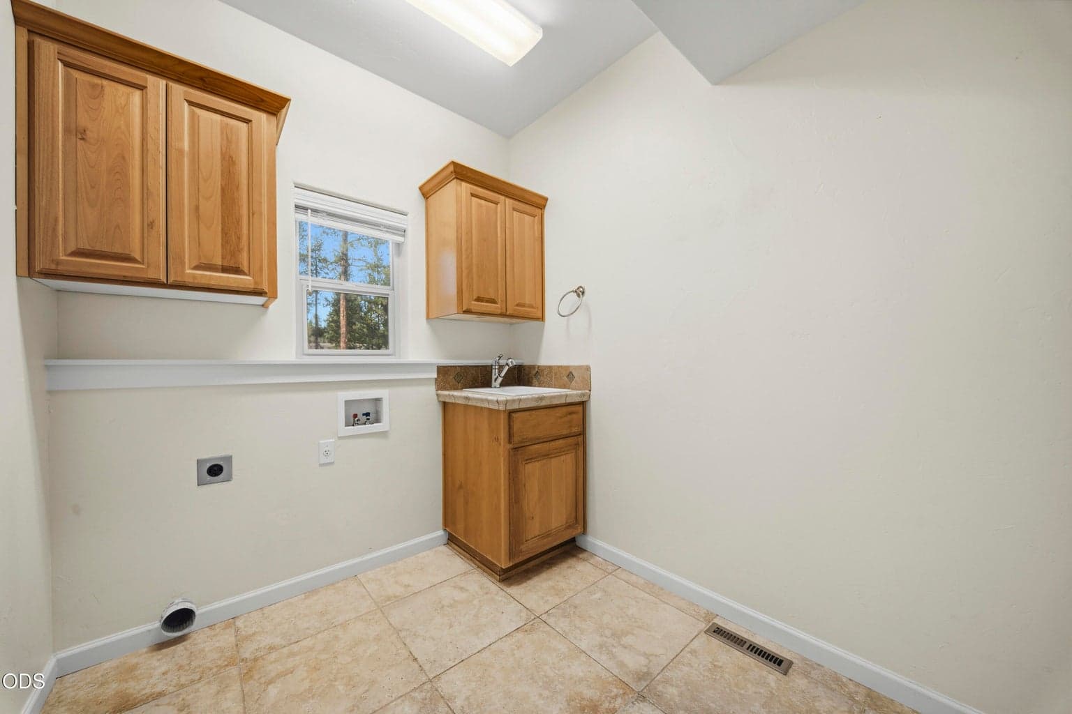 First floor laundry room with a sink; one of two in the house!