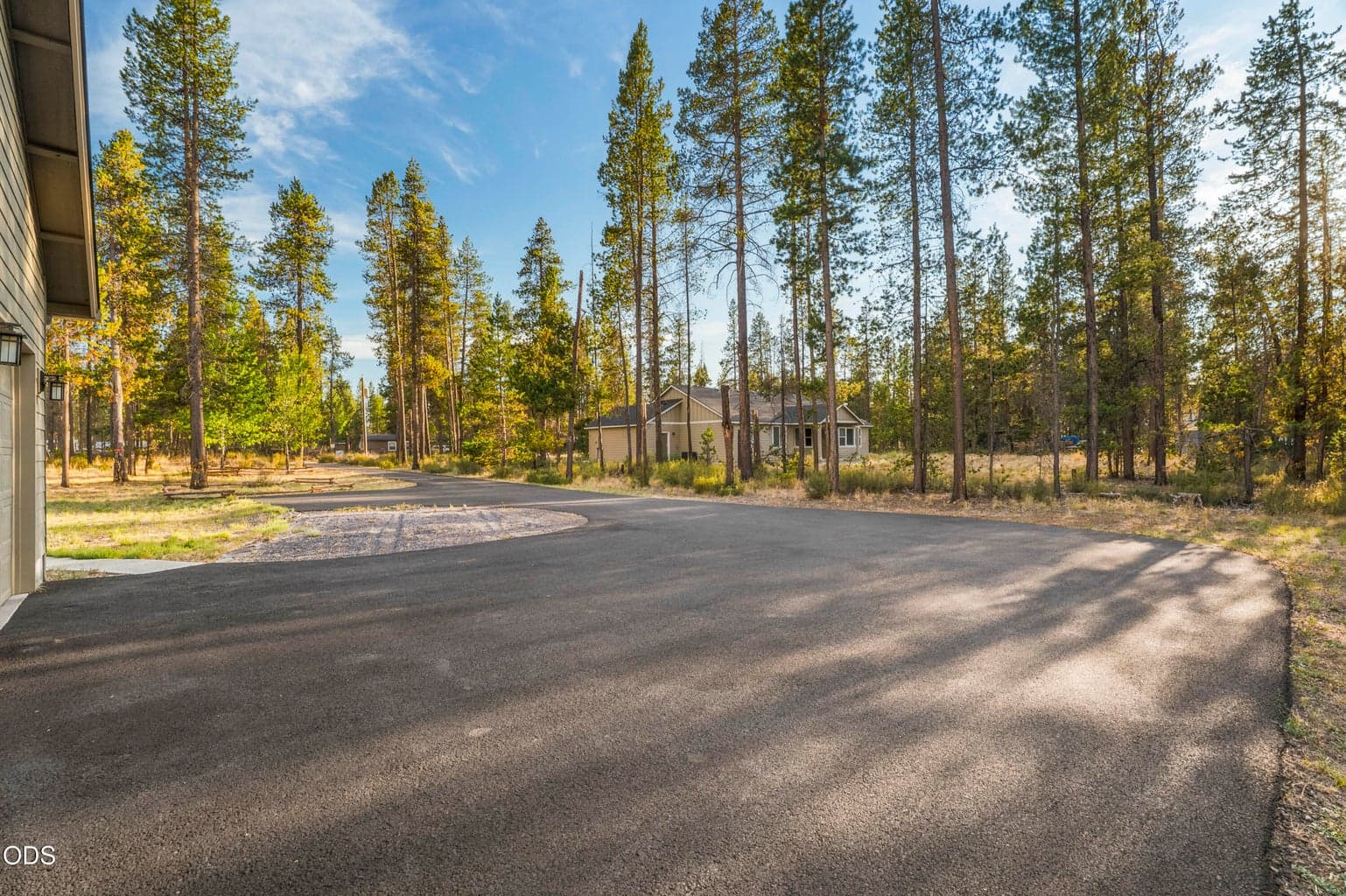 Large asphalt driveway meets up with the RV parking area and the 3 car garage!