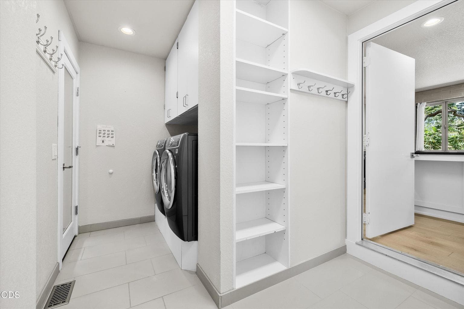 A utility room off of the garage features a washer and dryer and storage.