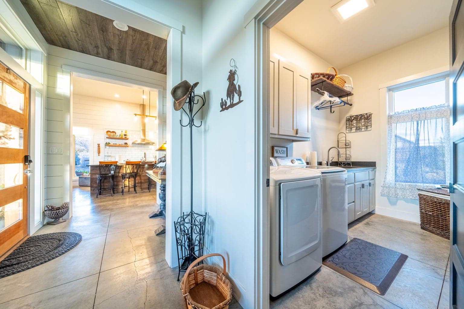 Bright utility room off garage entry and back hall with huge storage wall closet