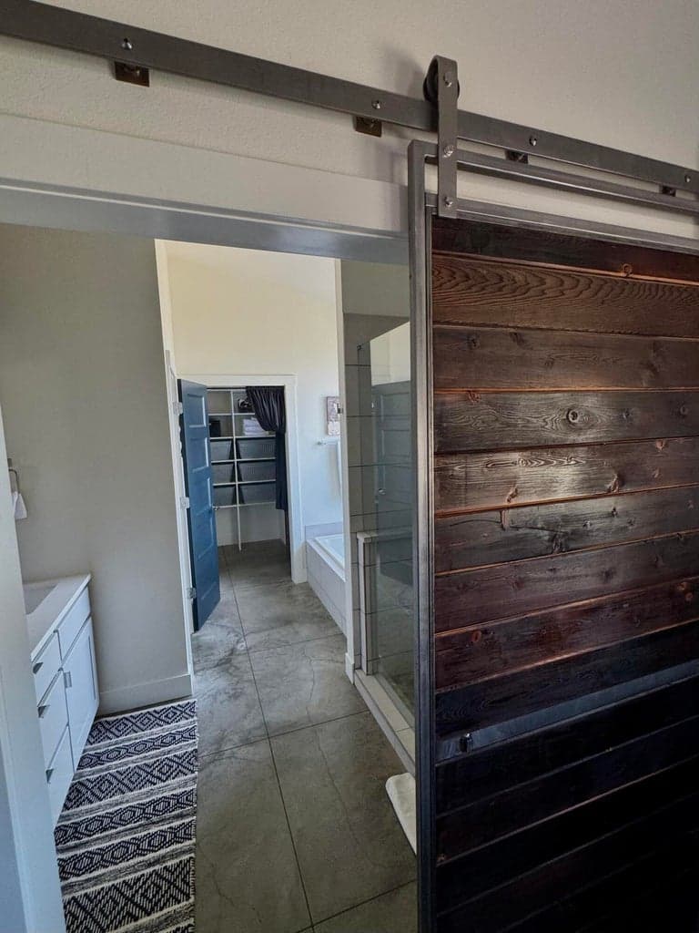 Custom wood barn door for bathroom access