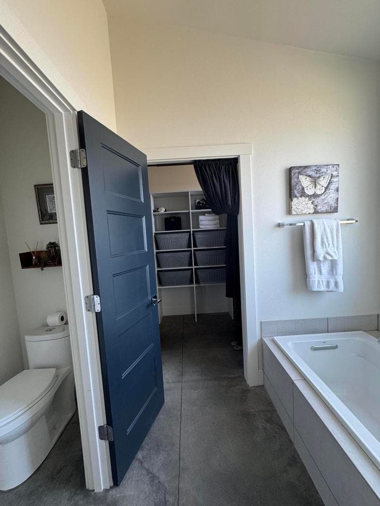 Large walk-in closet with lots of shelving and hanging space