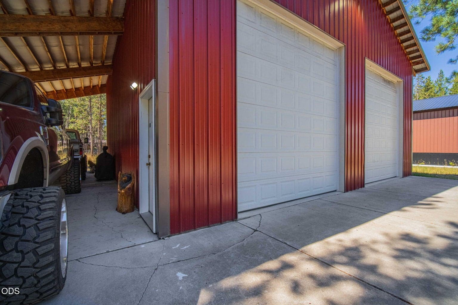 Open single slope shed roof allows for additional covered vehicle storage