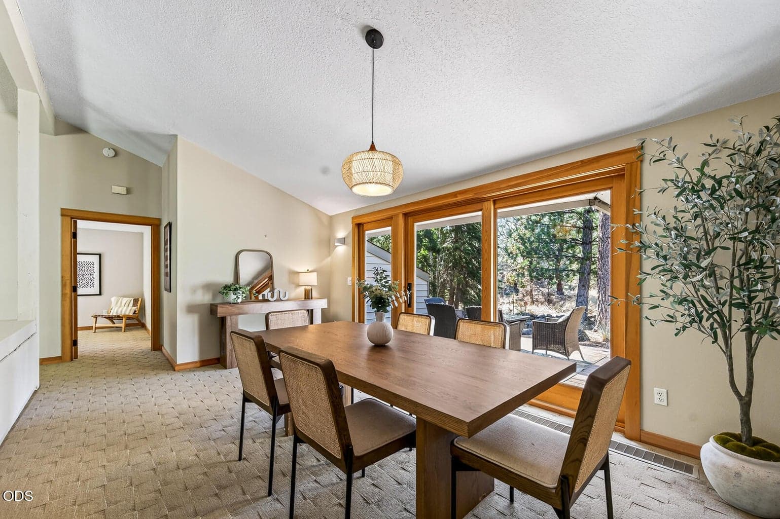 Dining room with outdoor dining beyond the glass doors
