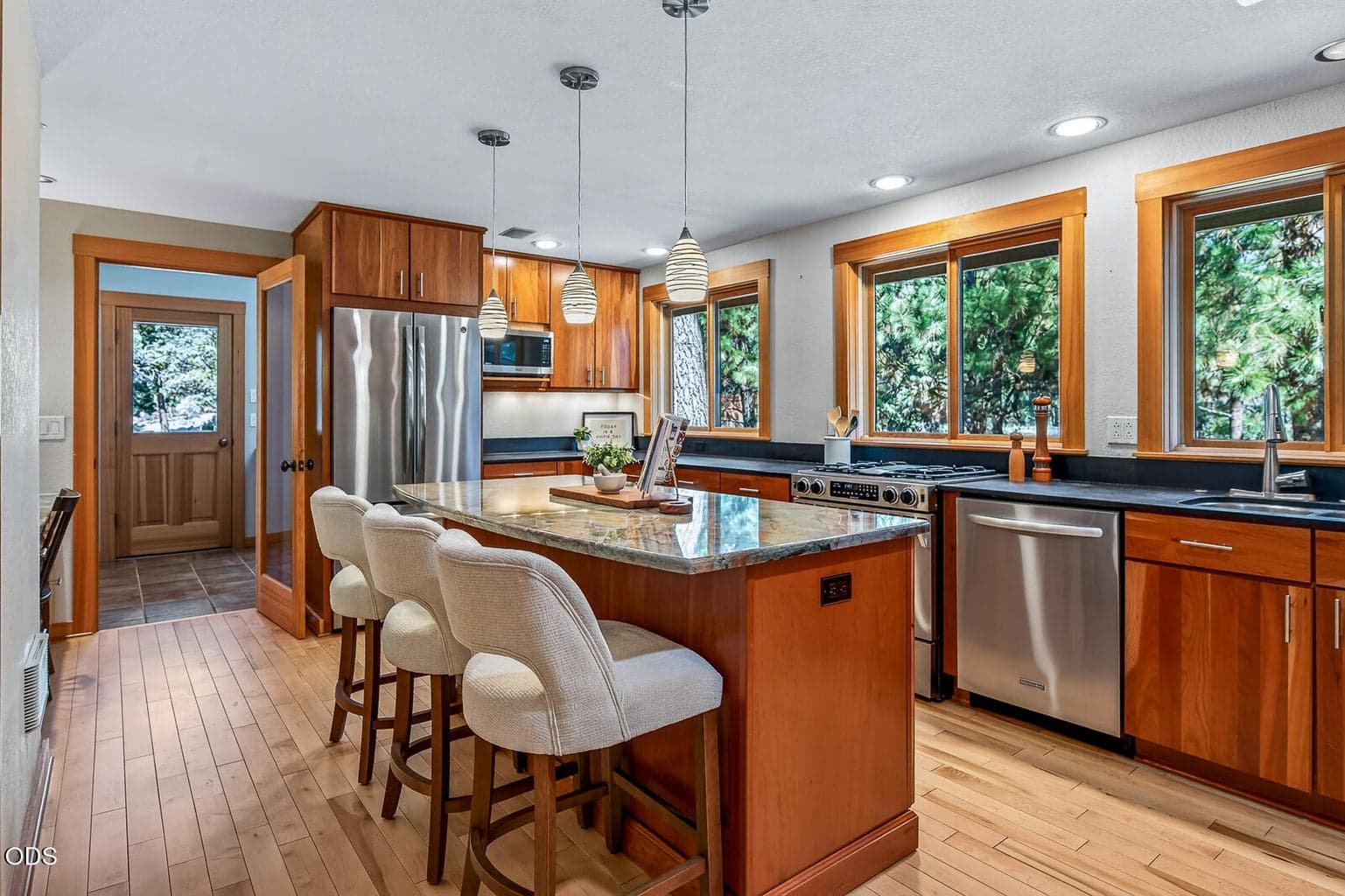 Gorgeous kitchen with granite island, stainless steel appliances and plenty of windows to enjoy the landscape views