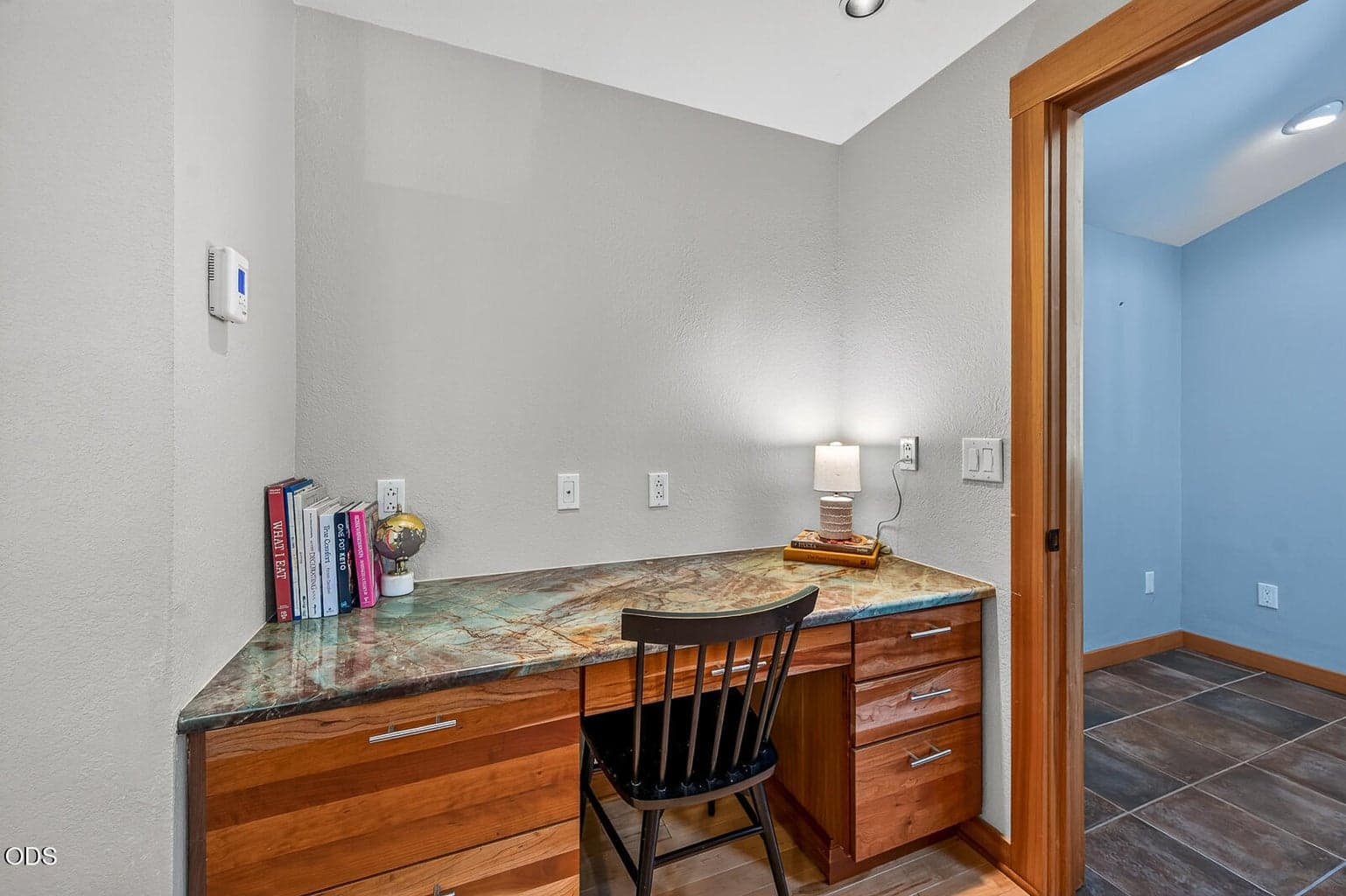 Built-in desk area with granite counter tucked away near the kitchen. The mudroom with plenty of storage is the room just beyond