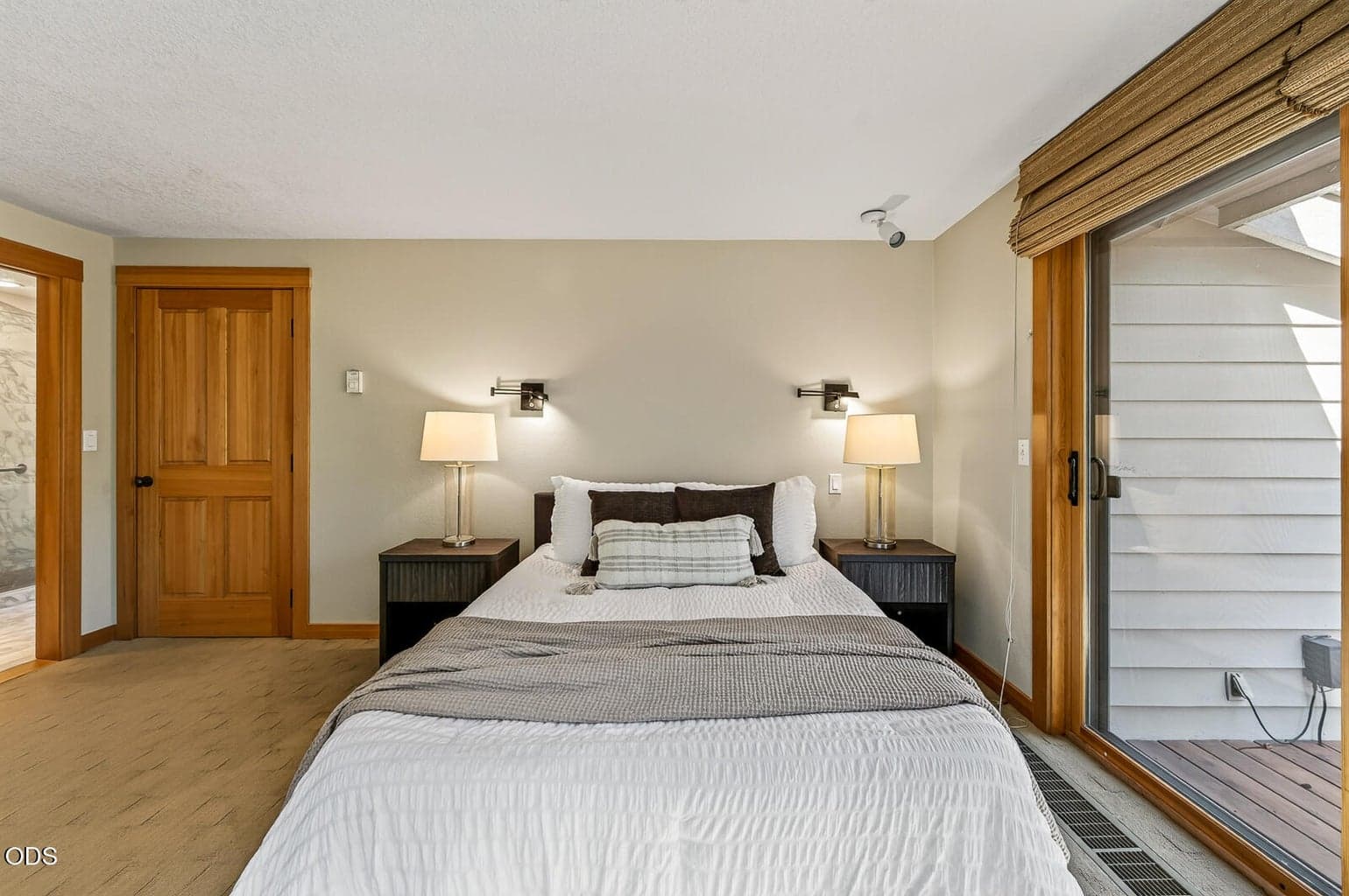 The closed door leads to the hallway to the living and dining areas. The door to the left leads to the primary bath and walk in closest
