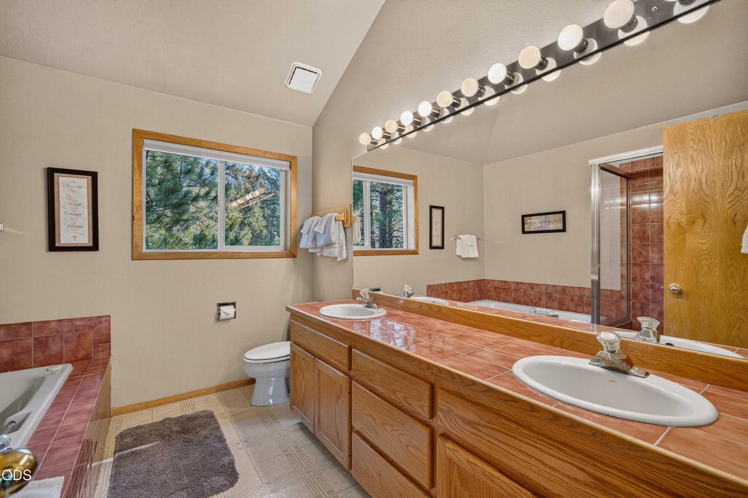 A generous primary bath provides double sinks and room to begin and end the day comfortably.