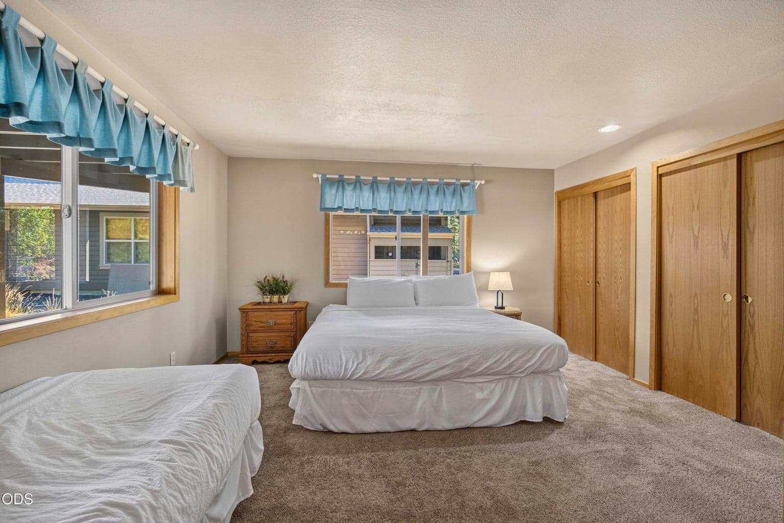 A second view of the downstairs suite highlights its generous proportions, natural light and flexible sleeping space for visiting family and friends.