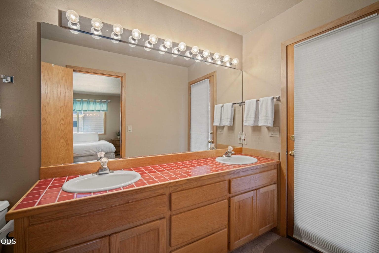 The downstairs suite includes its own well-appointed bath, creating a private and convenient retreat for overnight guests.