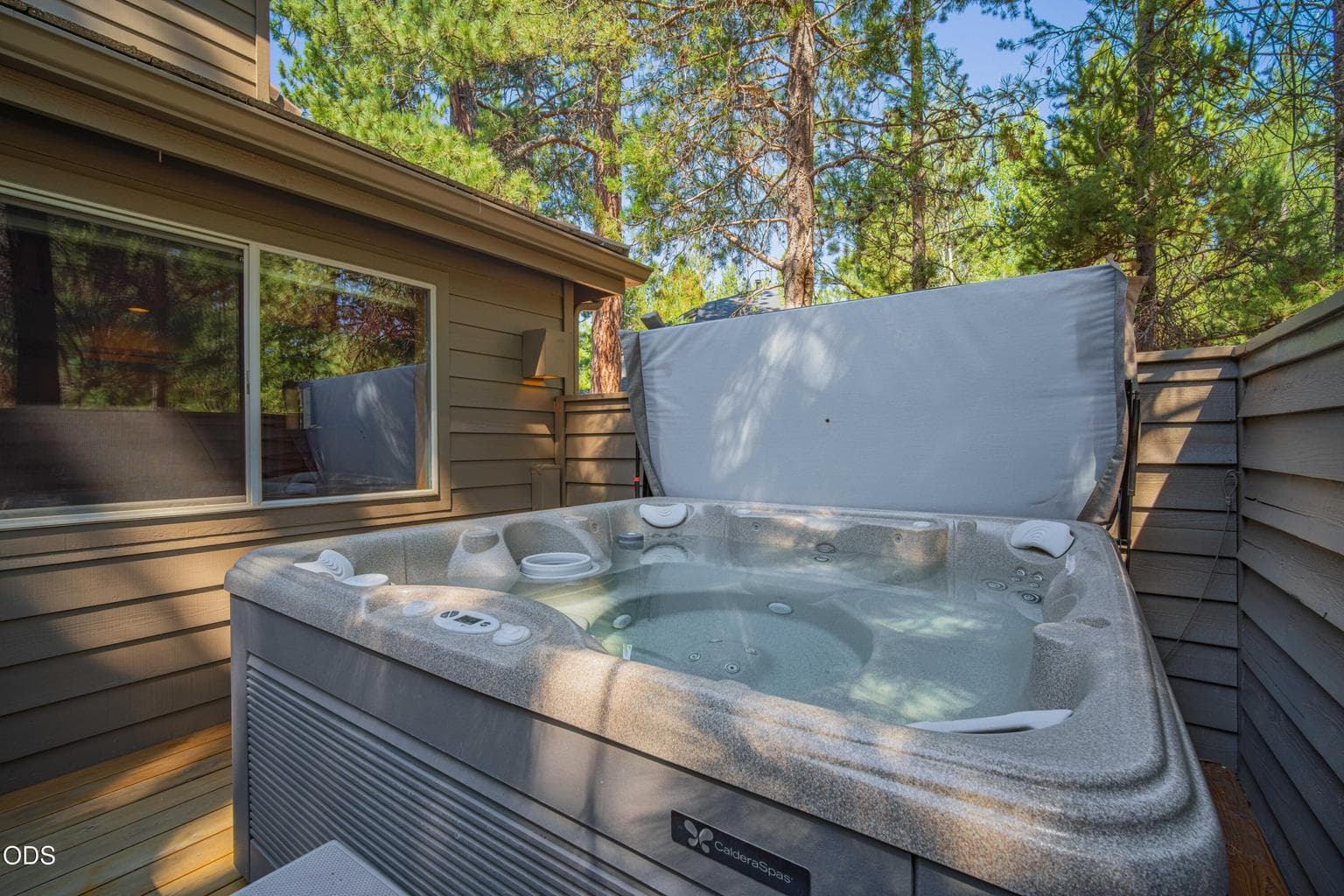 Soak beneath the pines in a private outdoor setting designed for year-round relaxation.
