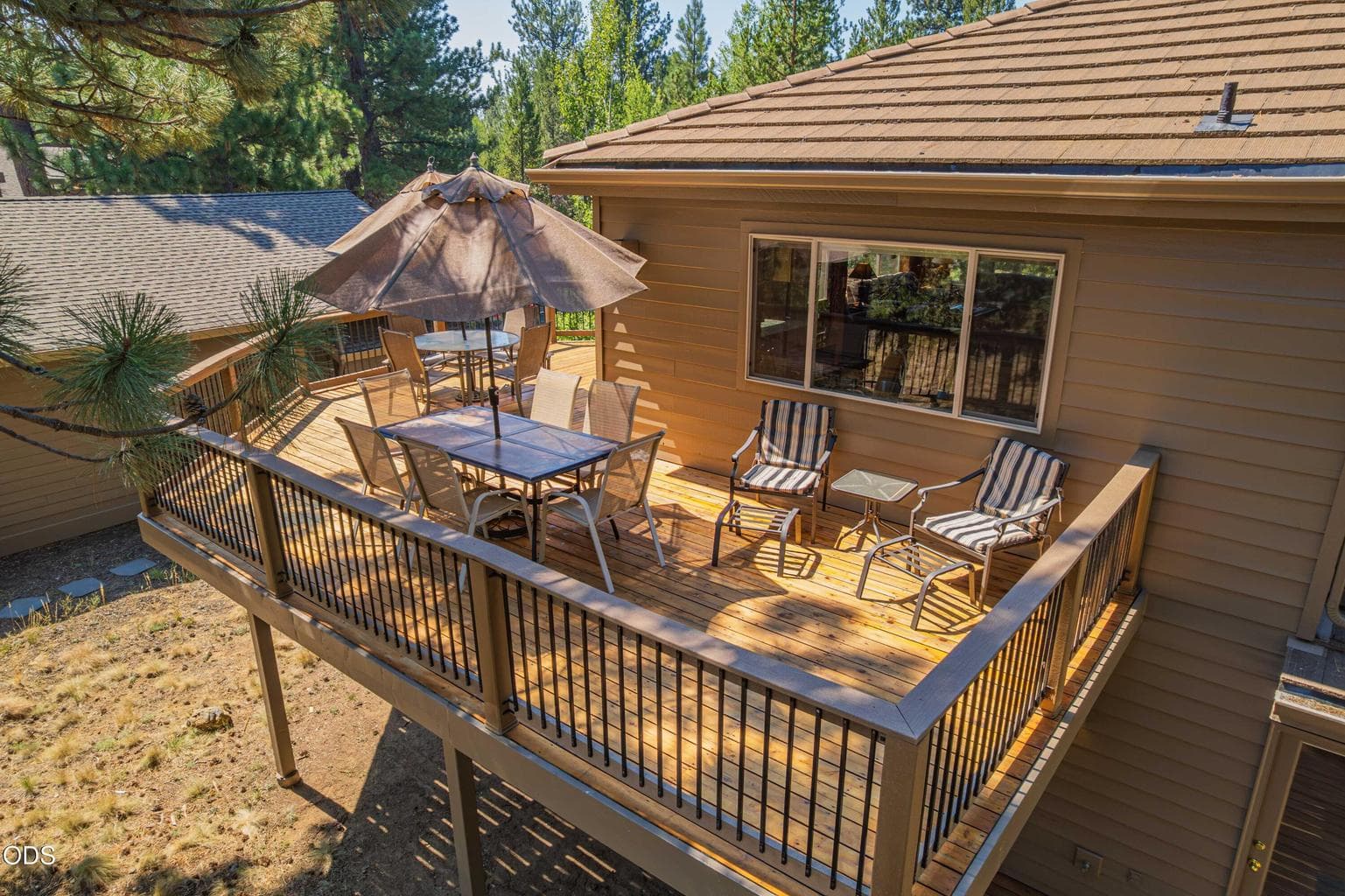 The rear of the home reveals multiple outdoor spaces designed for gathering, relaxing and taking in the setting.
