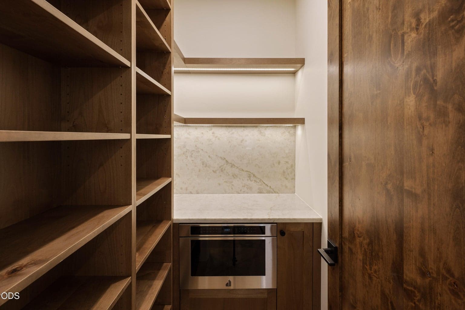 Custom Pantry with built in microwave and under shelving lighting