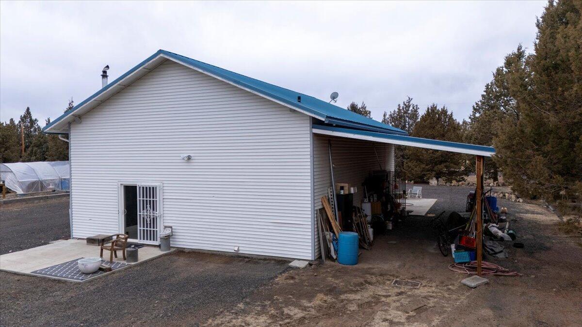Covered carport area off the side of the shop.
