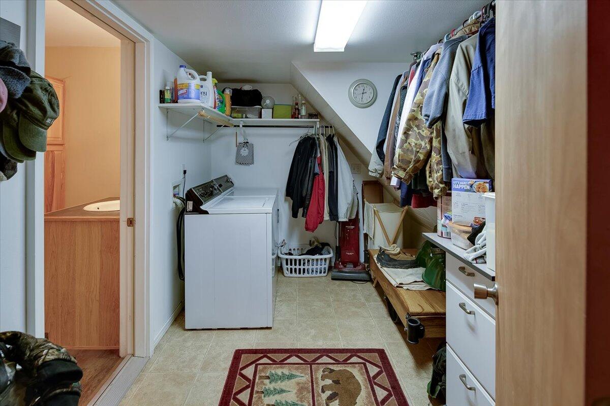 Laundry/utility room in shop with door to bathroom