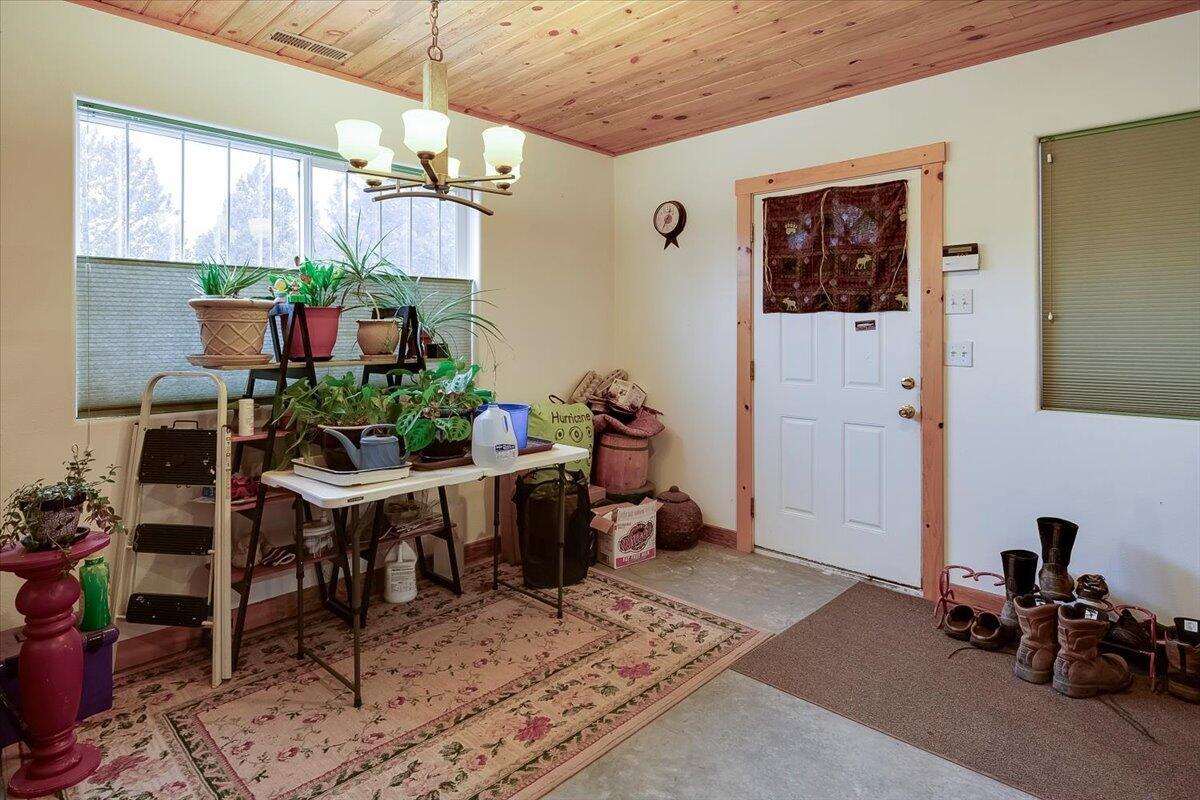 Dining area in shop with door to attached carport on the north side of the building.