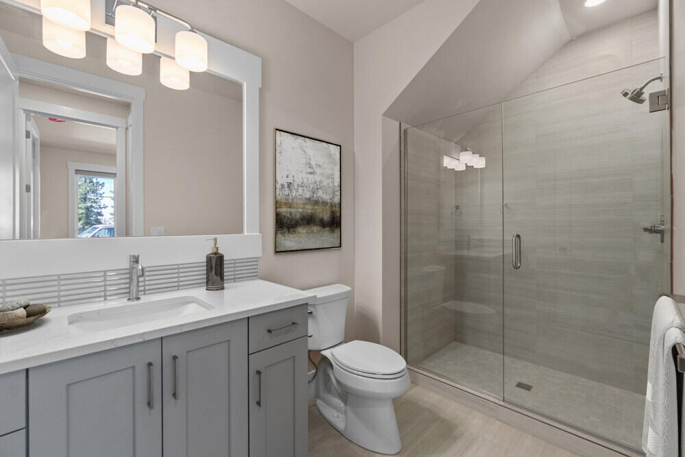 Downstairs guest full bath off of flexroom/bedroom #4. Photo of similar home model. Specs vary.