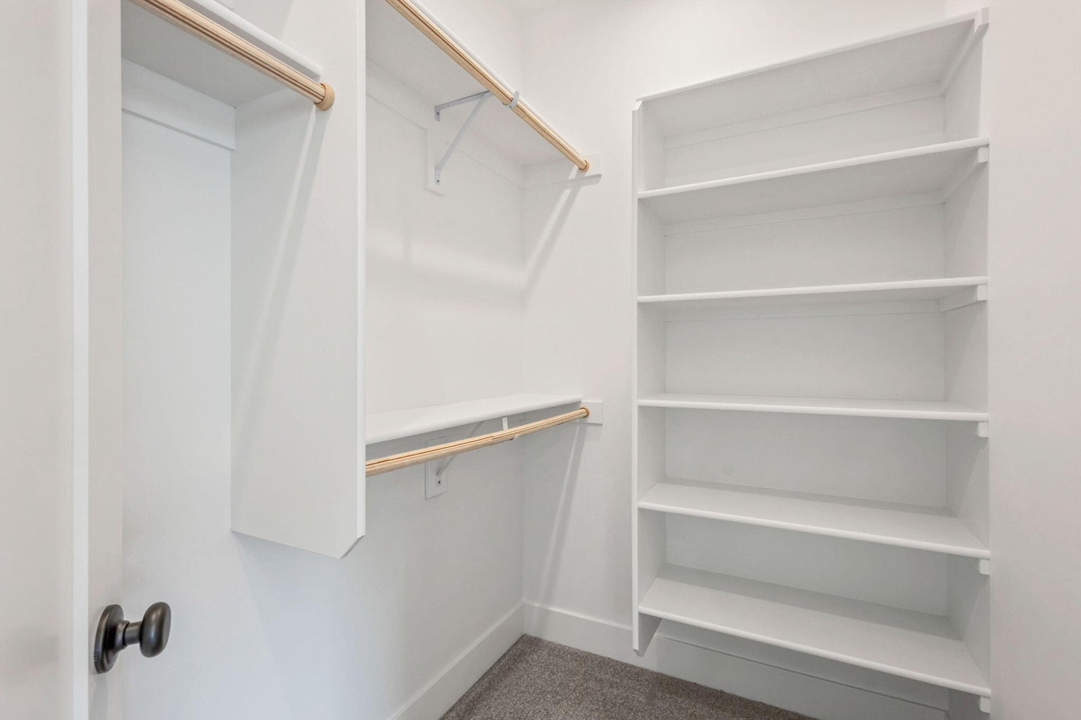 Large walk in closet with wood shelving