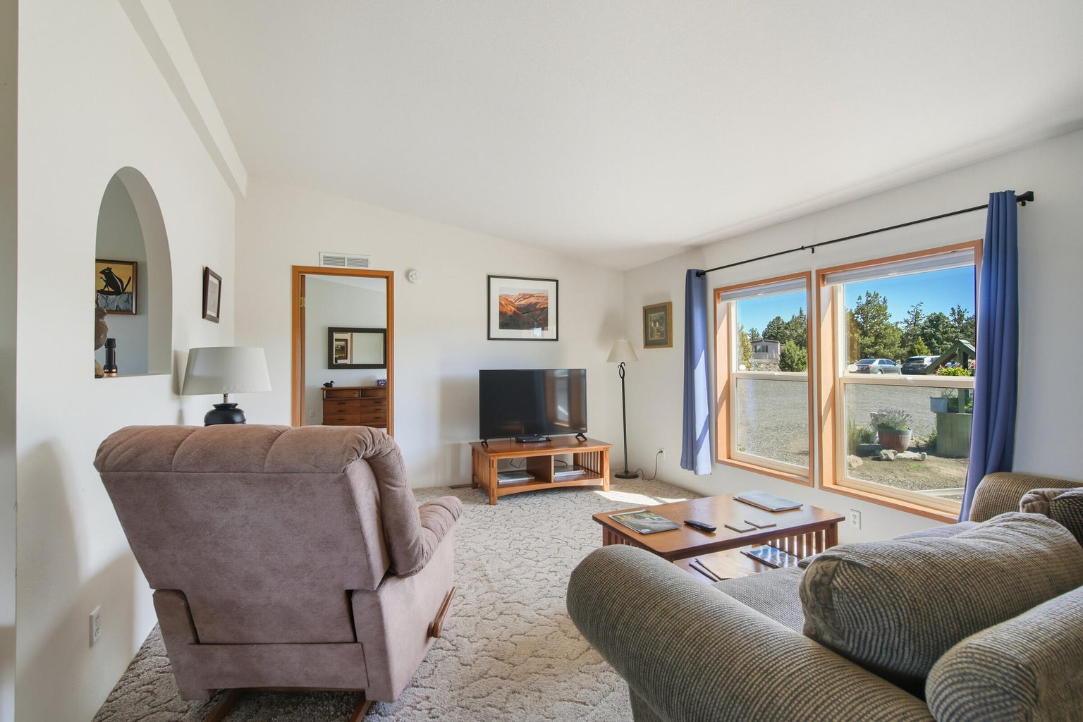 manufactured home living room with access to separated primary bedroom