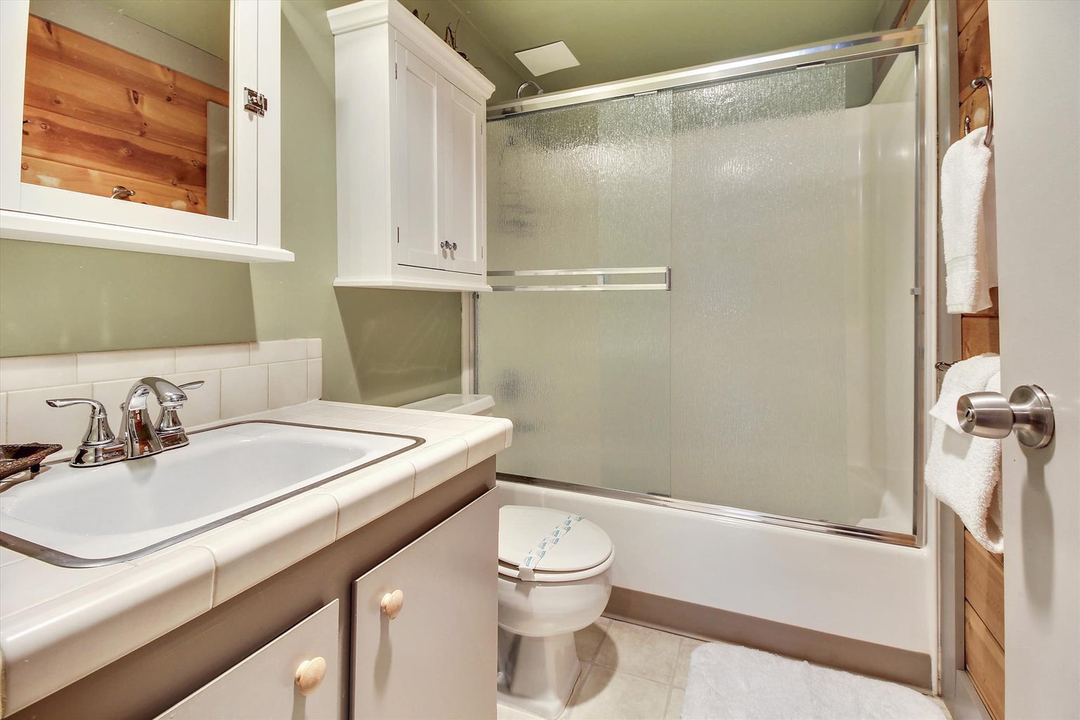 An updated guest bathroom offers the perfect balance of convenience and relaxation.