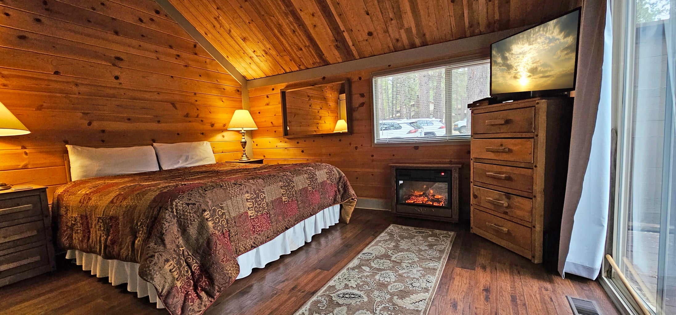 This cozy suite on the main floor offers the perfect retreat for restful nights, featuring an inviting electric fireplace for added comfort.