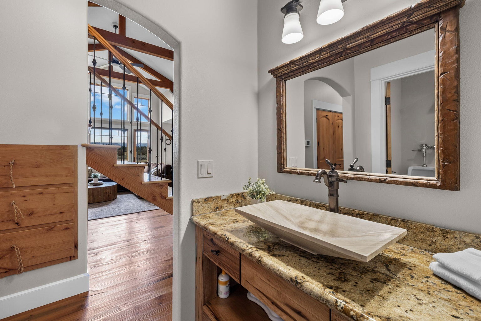 Doorway leads to storage drawers under the stairs and then the Great Room.