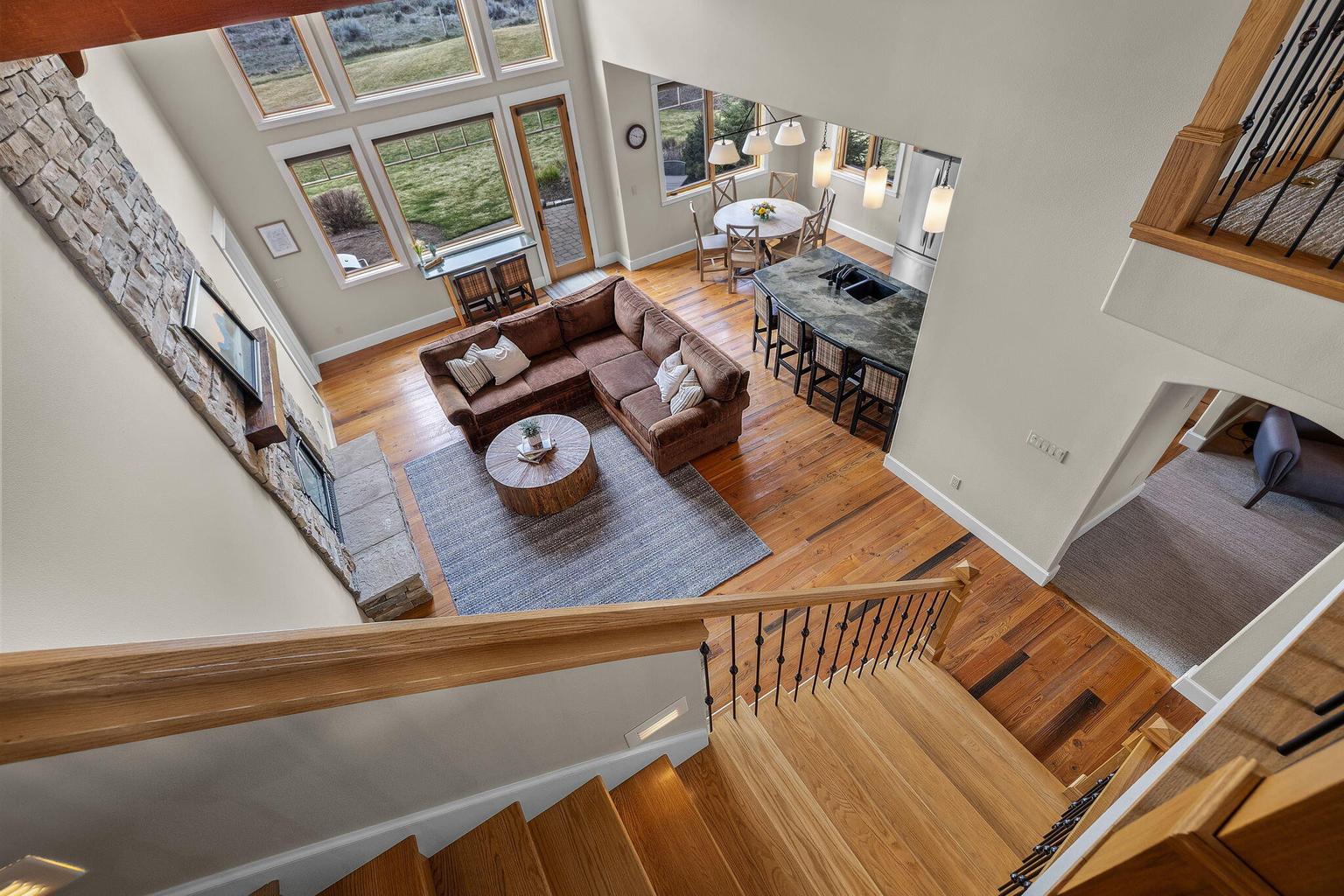Double height real stone fireplace anchors the room!