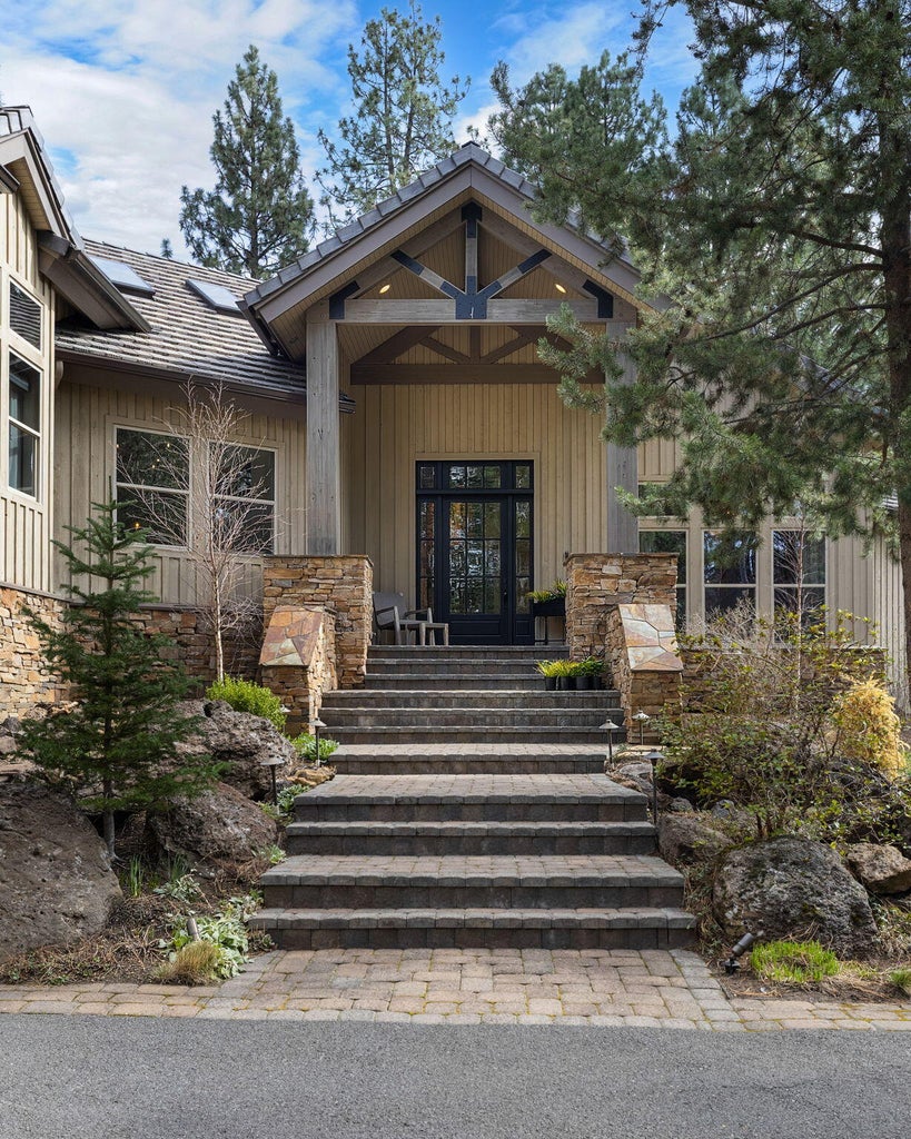 8-ft front door with sidelights and transom window, allowing natural light to fill the entry and enhance the home’s architectural presence.
