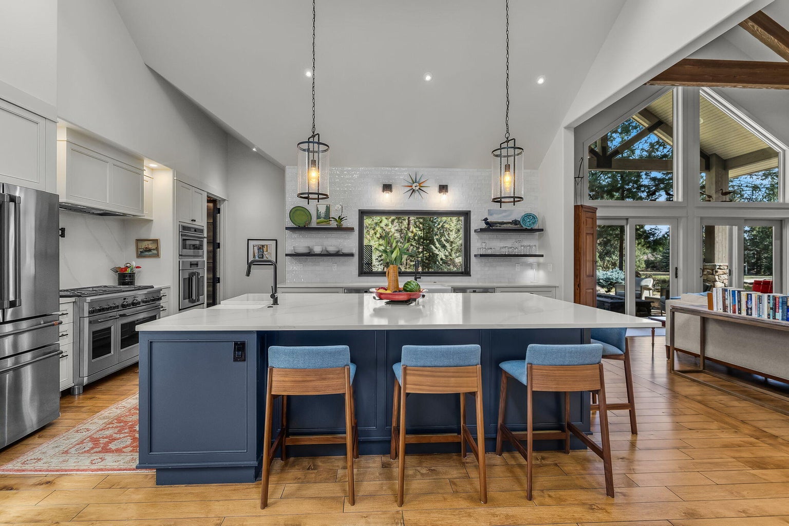 Well-appointed kitchen anchored by a generous island with bar seating, complemented by high-end appliances, custom cabinetry, and a seamless connection to the surrounding living spaces.