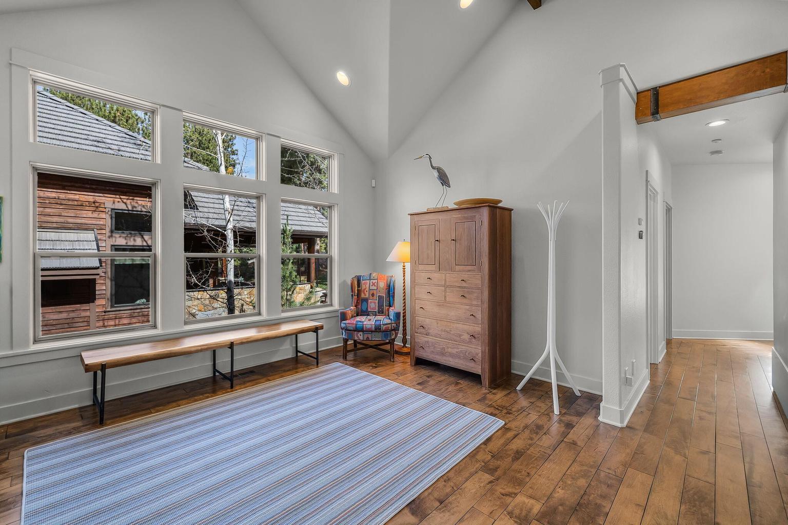 Central bonus area within the guest wing, connecting all four bedrooms and leading to the family/theater room.