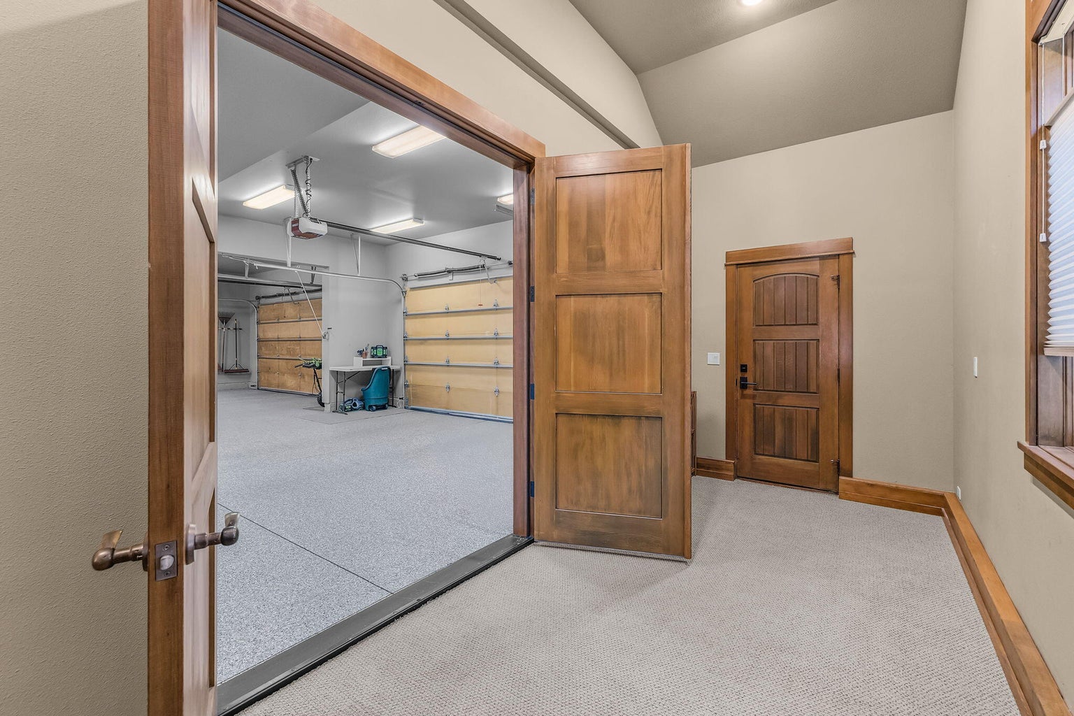 Versatile finished flex space off the garage with exterior access, ideal for storing outdoor gear, a workout area, or additional use.