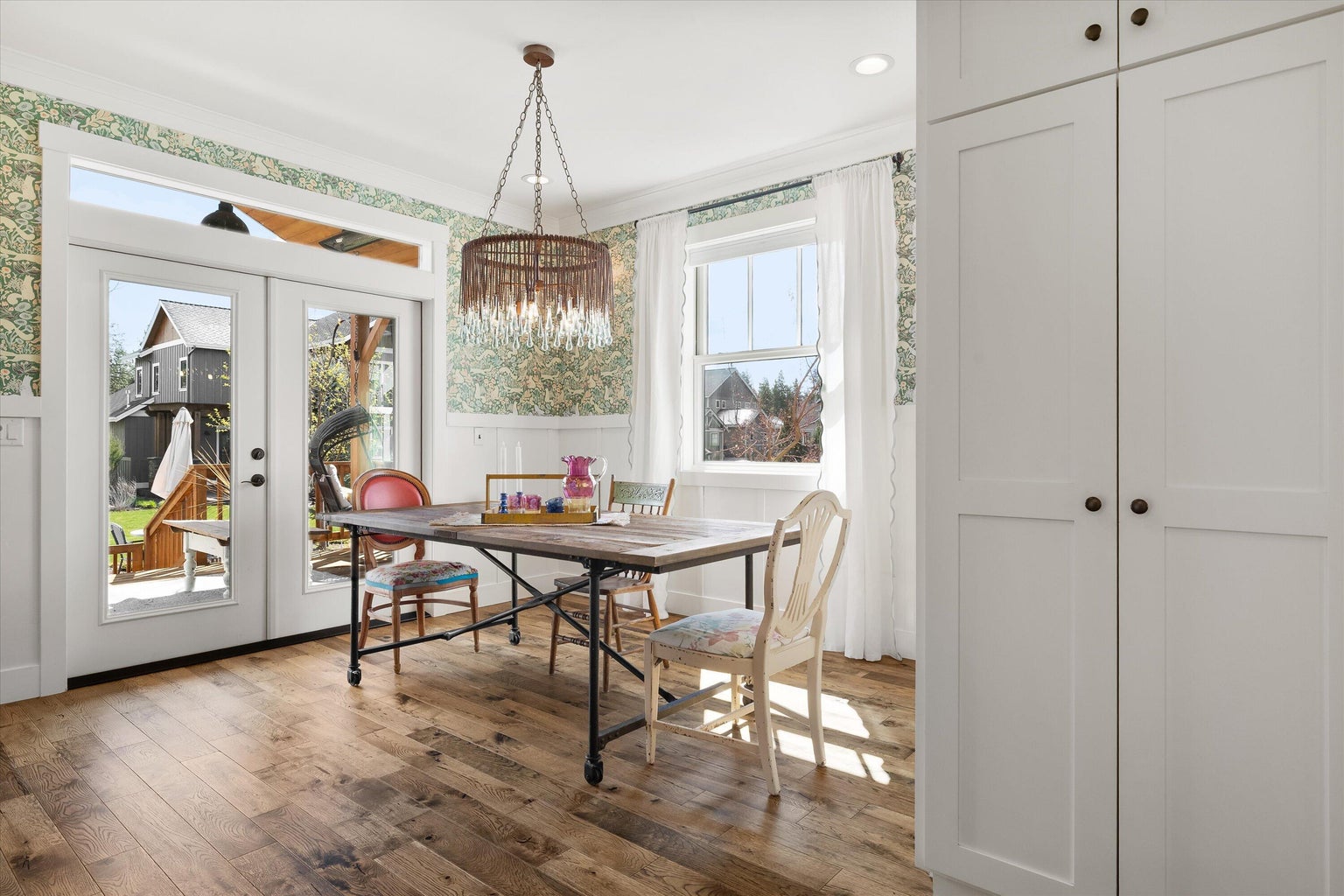 Dining Room with Wainscotting and French Doors to Back Deck