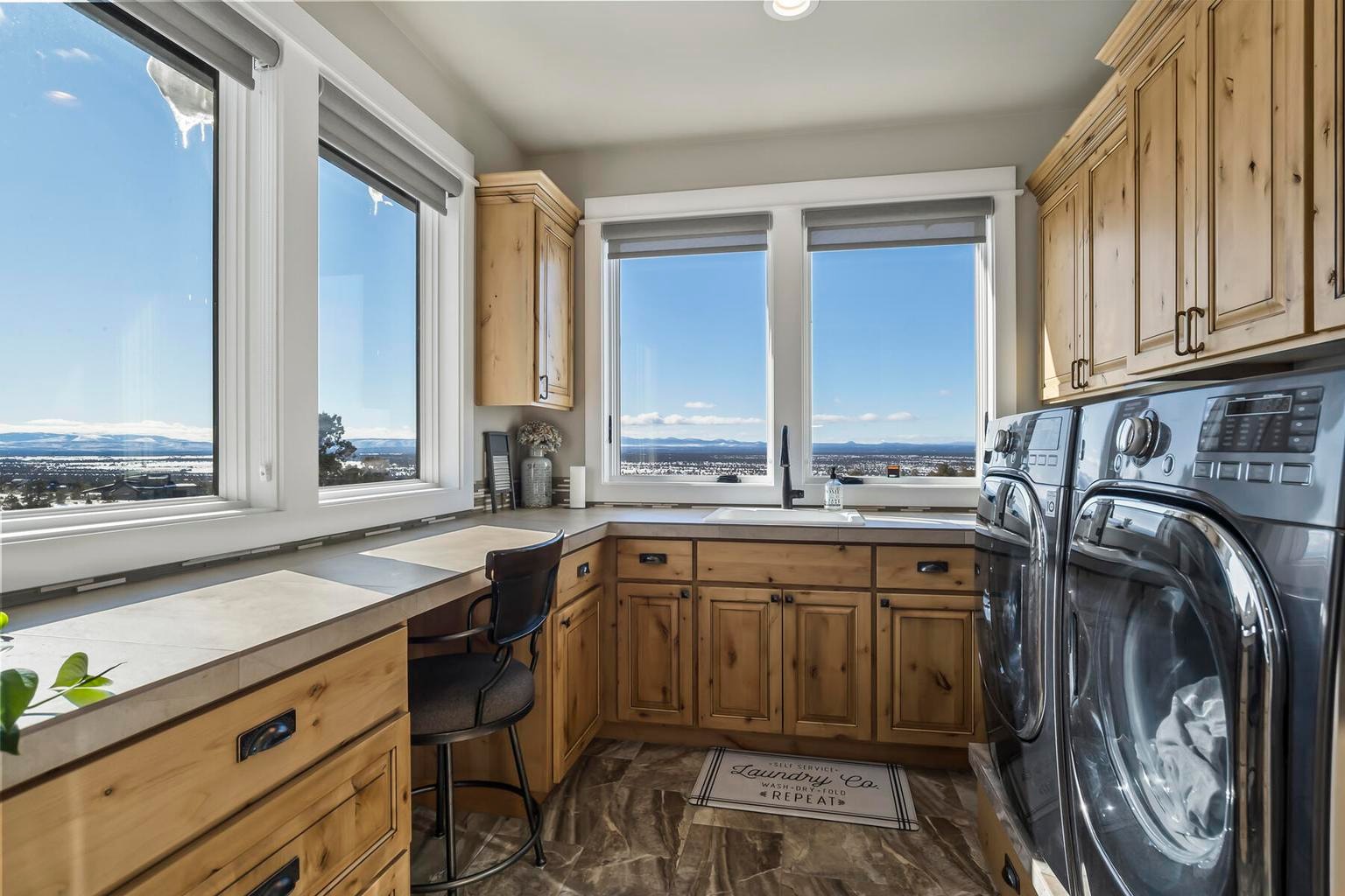 Light and bright laundry room with LG appliances and butte views. Counter area for crafting.