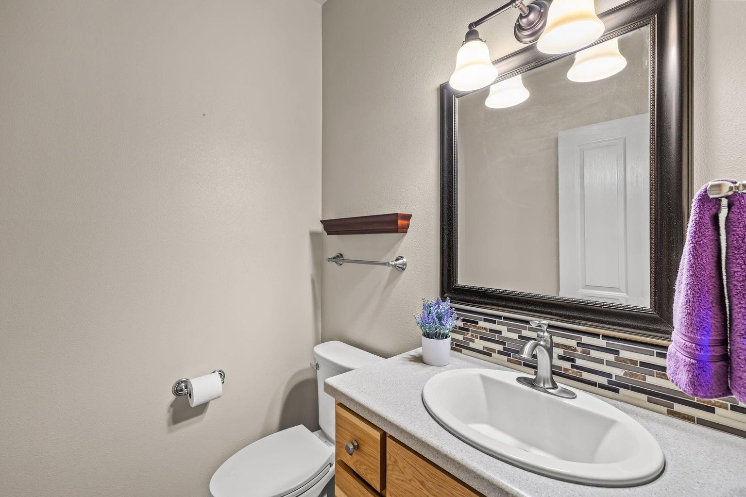 Half bath conveniently located near garage on main floor.