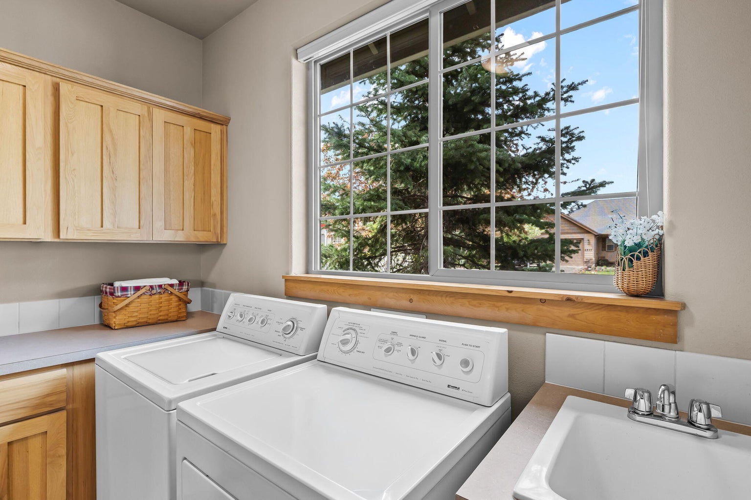 There are lots of cabinets and a laundry sink