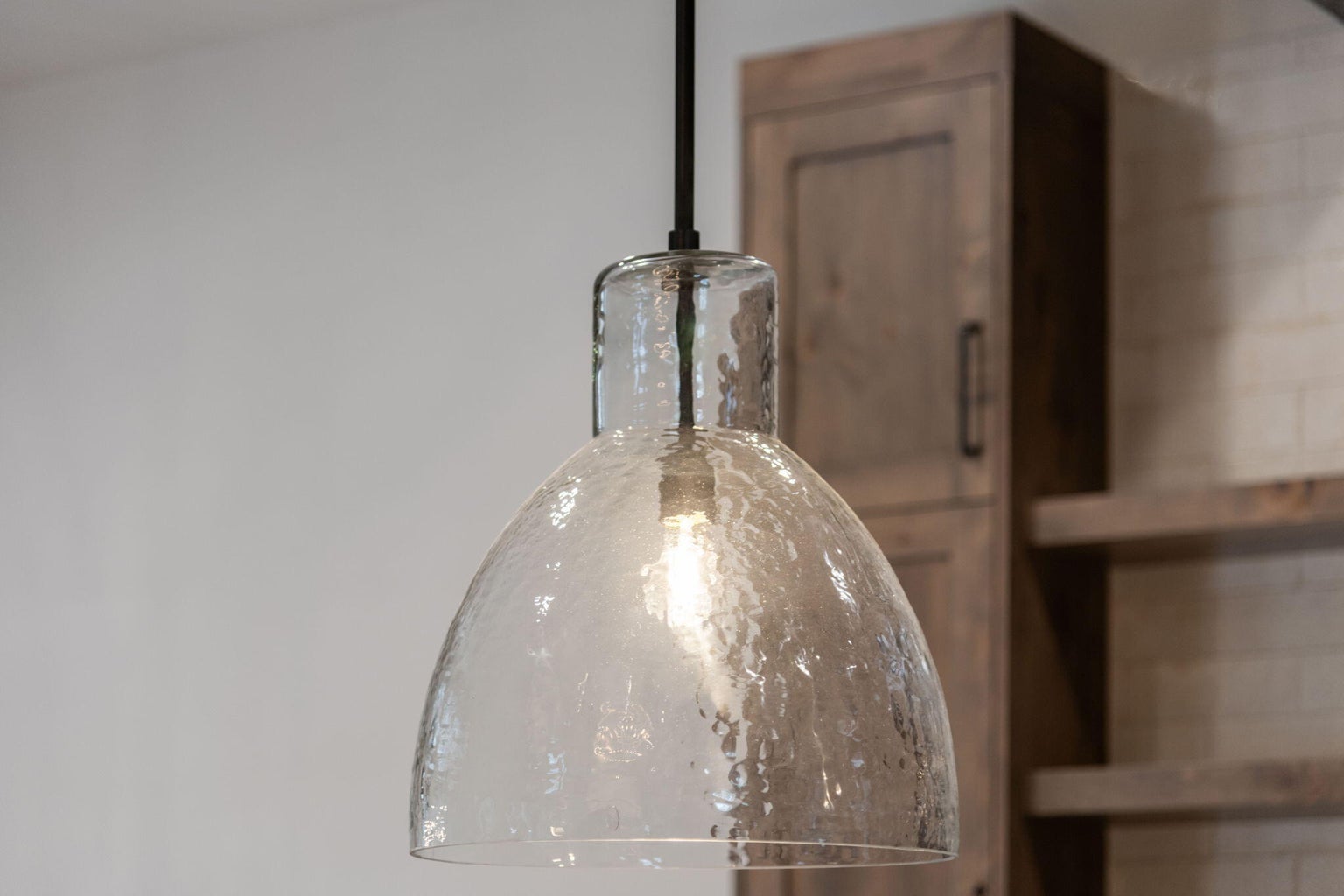 Stunning light fixtures from Restoration Hardware, West Elm and Pottery Barn through the home including over the kitchen island