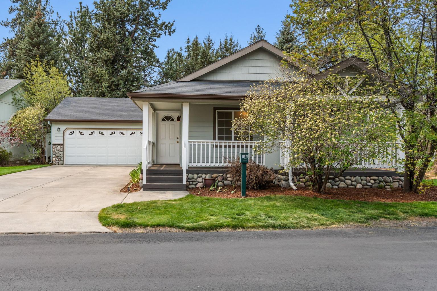 Large driveway, covered deck and front lawn.