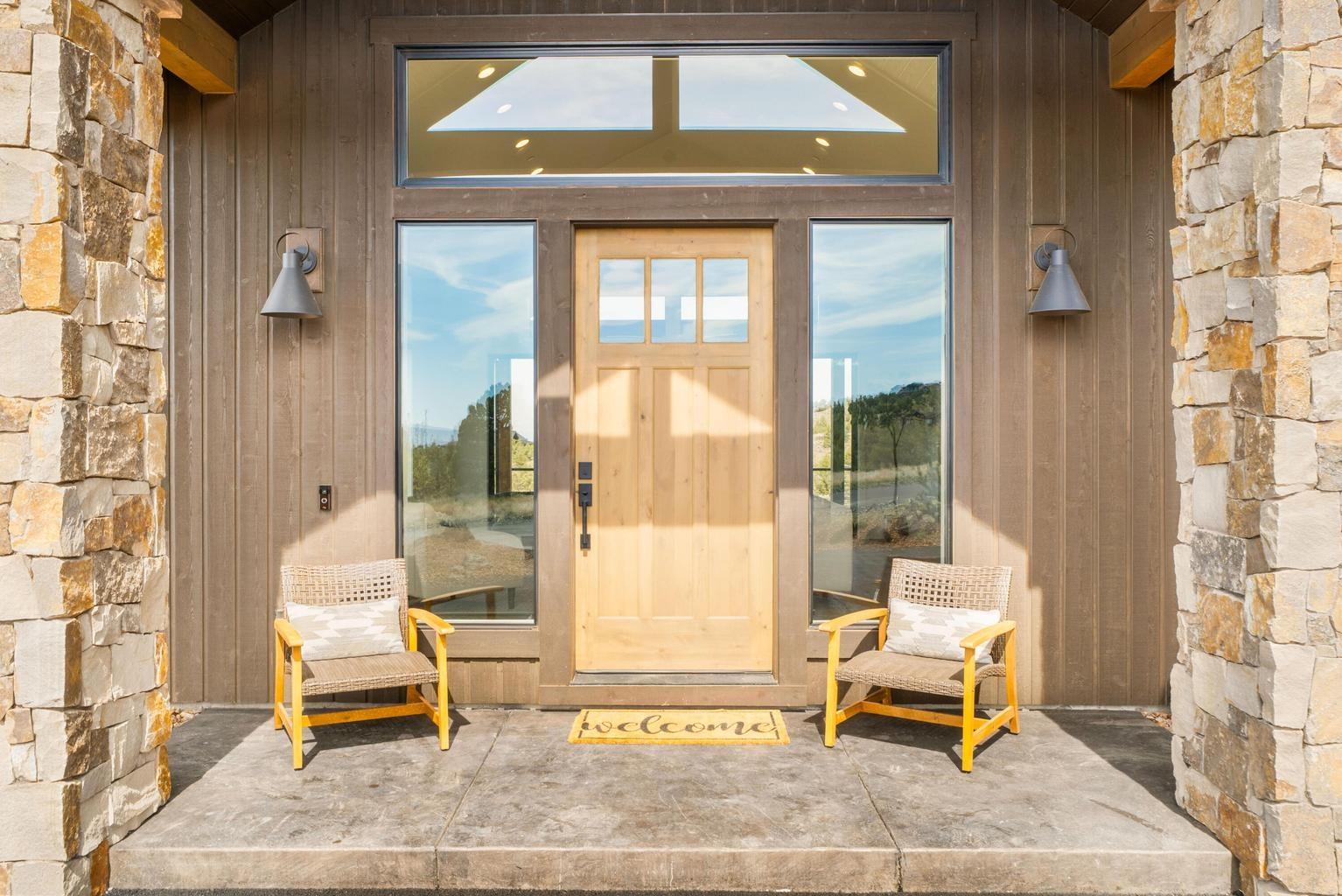 Welcoming covered front patio. Windows to great room