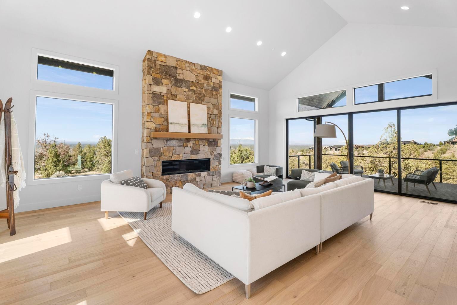 Stone fireplace, vaulted ceilings, and numerous windows make the space bright and light