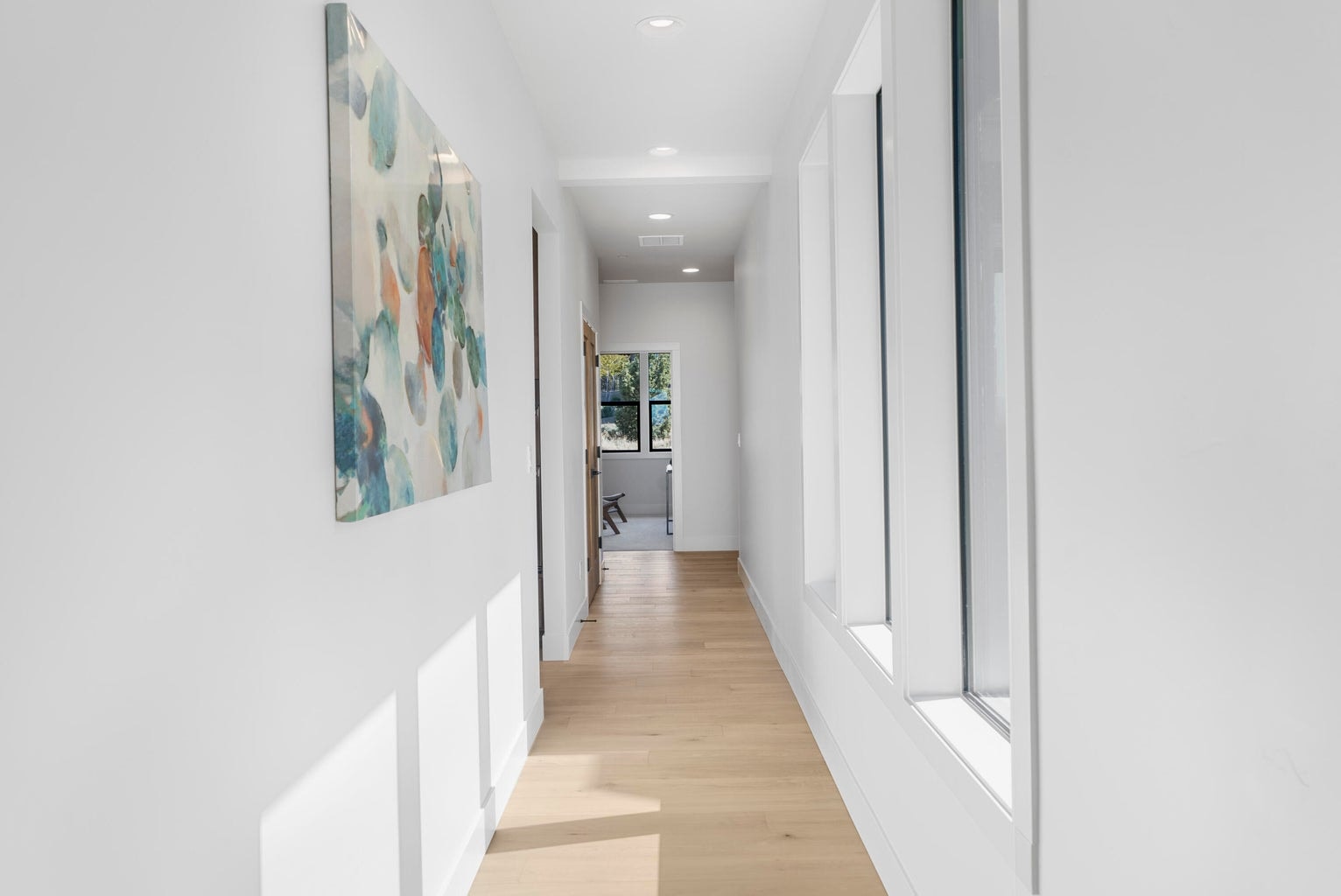 Light pours in the hallways of this home offering walls for galleries and smooth paths of traffic