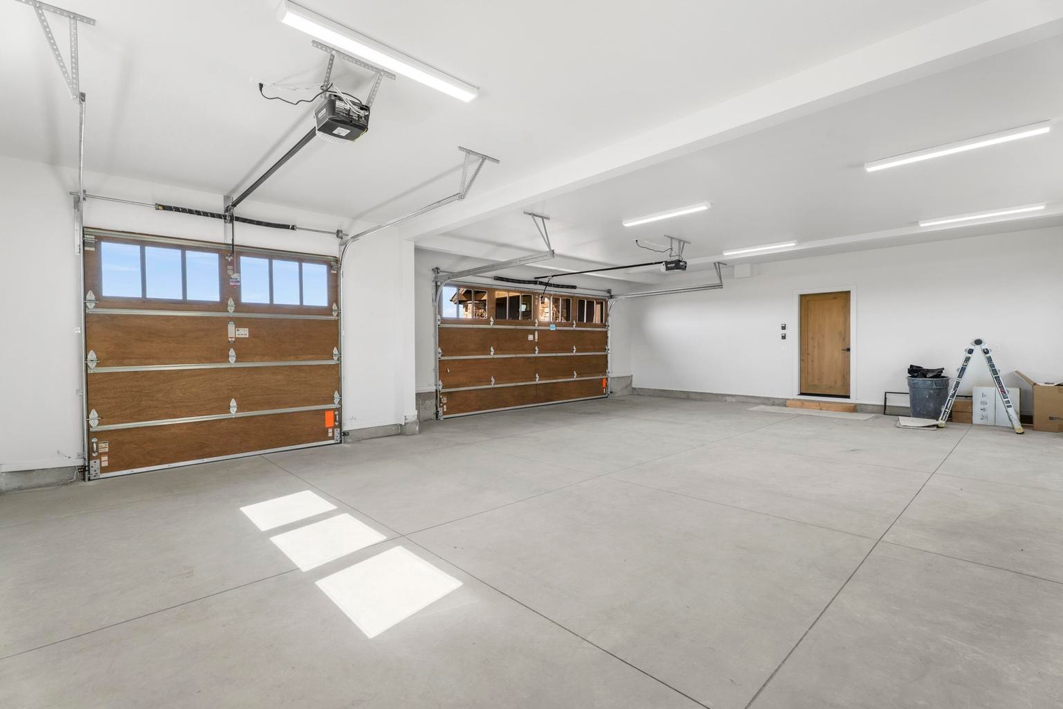 Three car garage. Windows behind let in lots of natural light