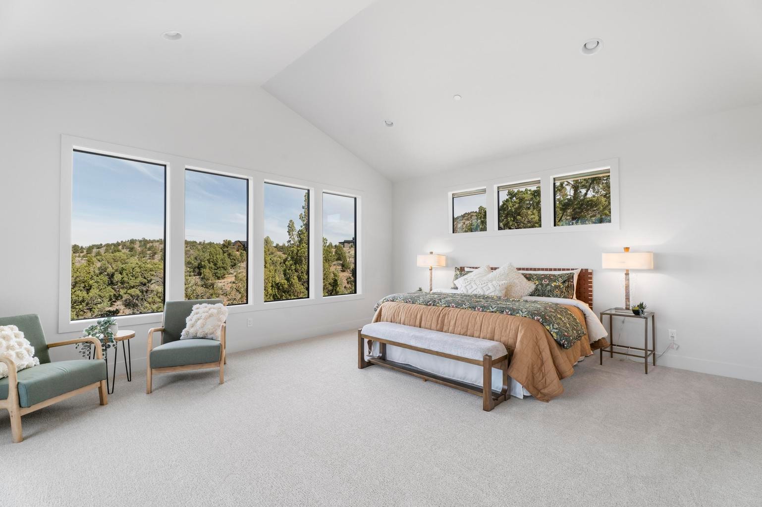 Grand primary suite with more of the home's signature windows and vaulted ceilings