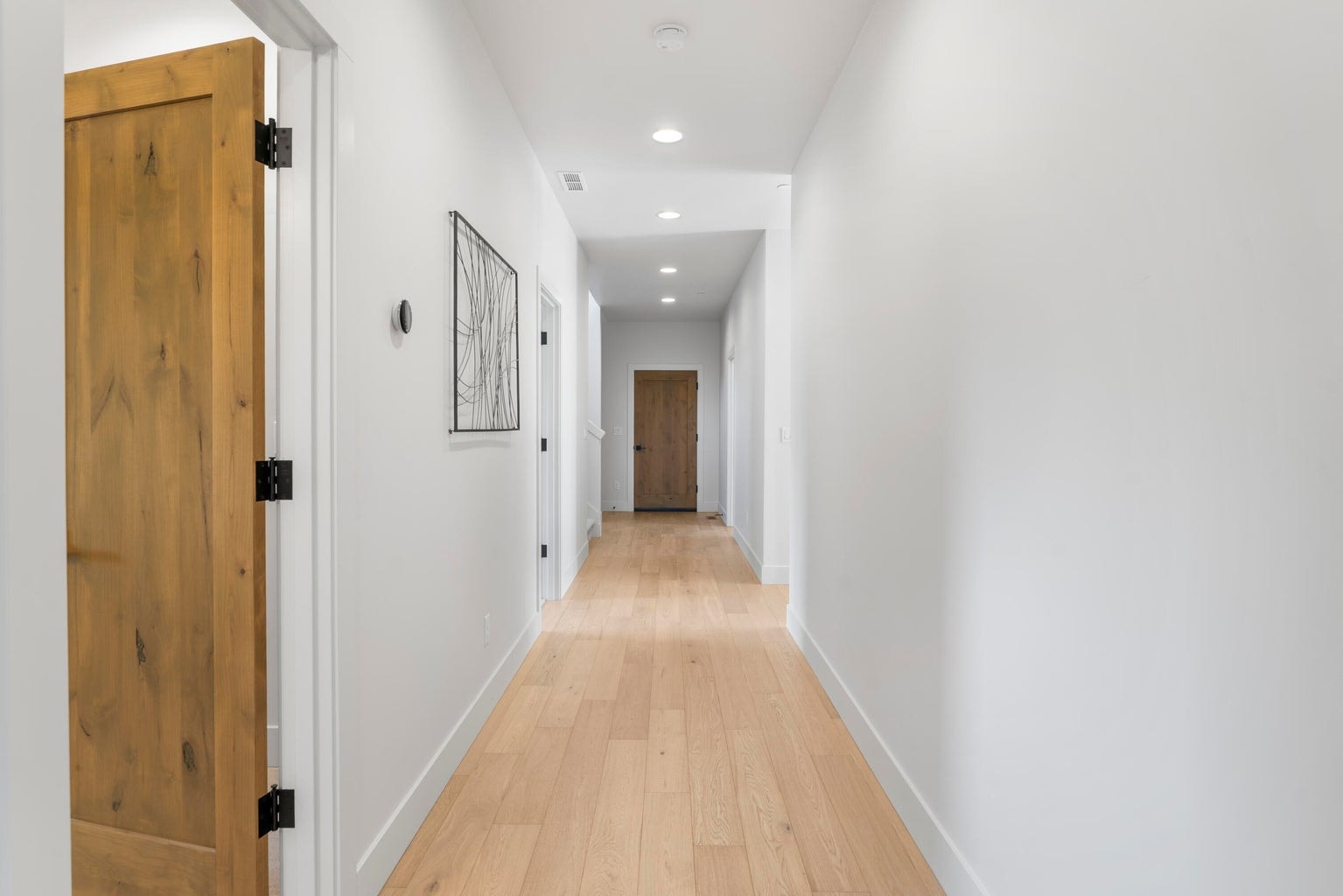 Back downstairs, the hallway that connects the stairs to laundry and garage