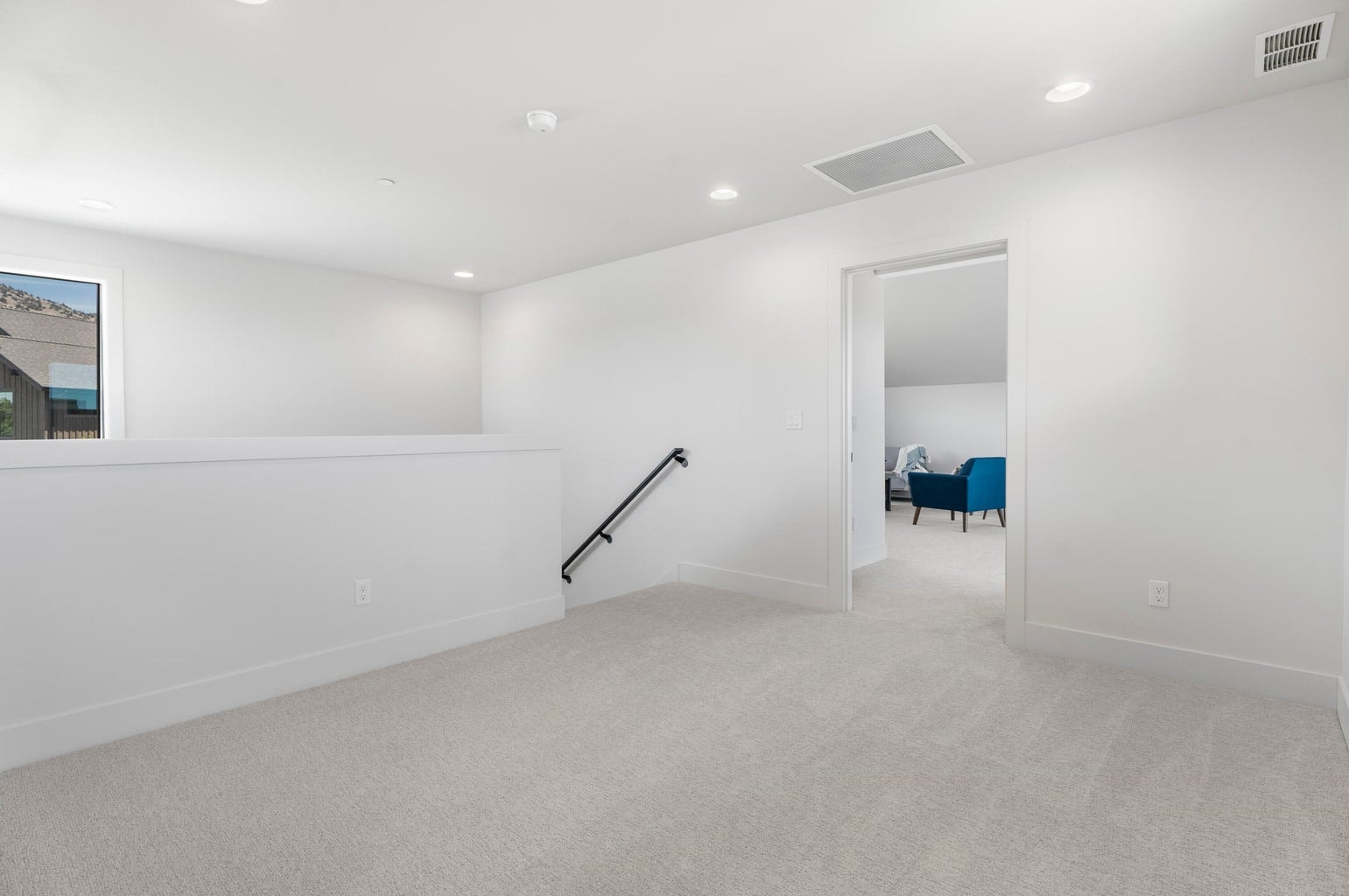 At the top of the stairs, a landing connects the bonus room and bathroom to two more bedrooms and a bathroom