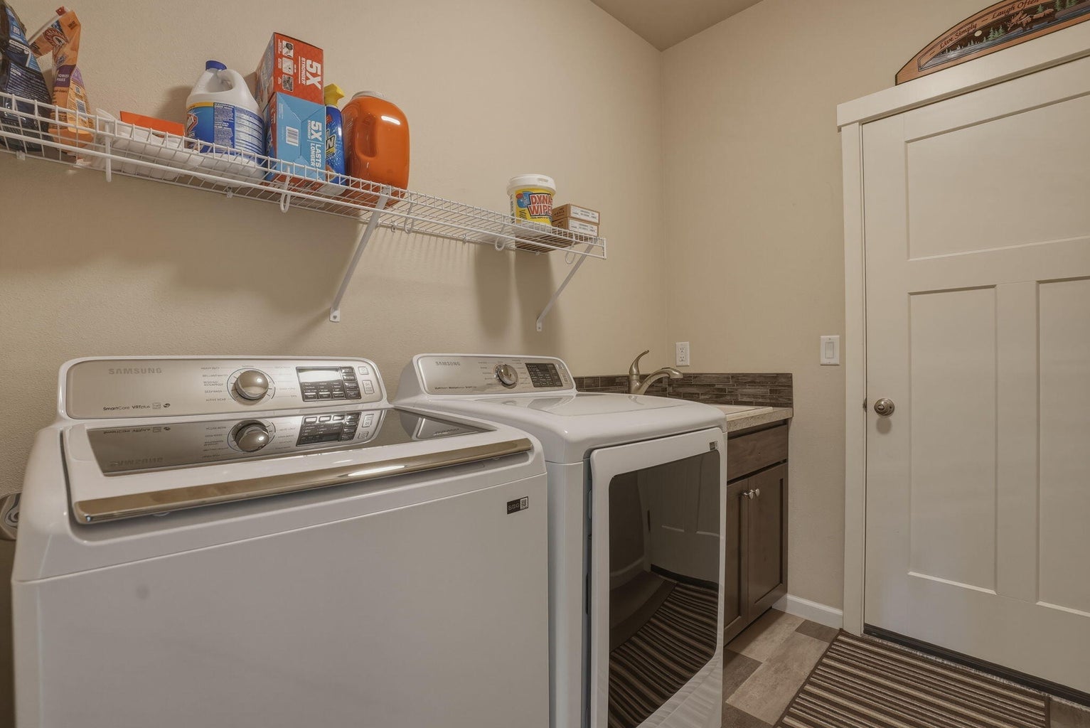 Laundry with utility sink and included washer and dryer